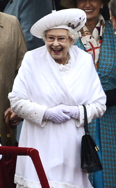 the-queen-wrapped-up-by-now-after-four-hours-of-standing-in-the-rain-still-enjoying-the-celebrations