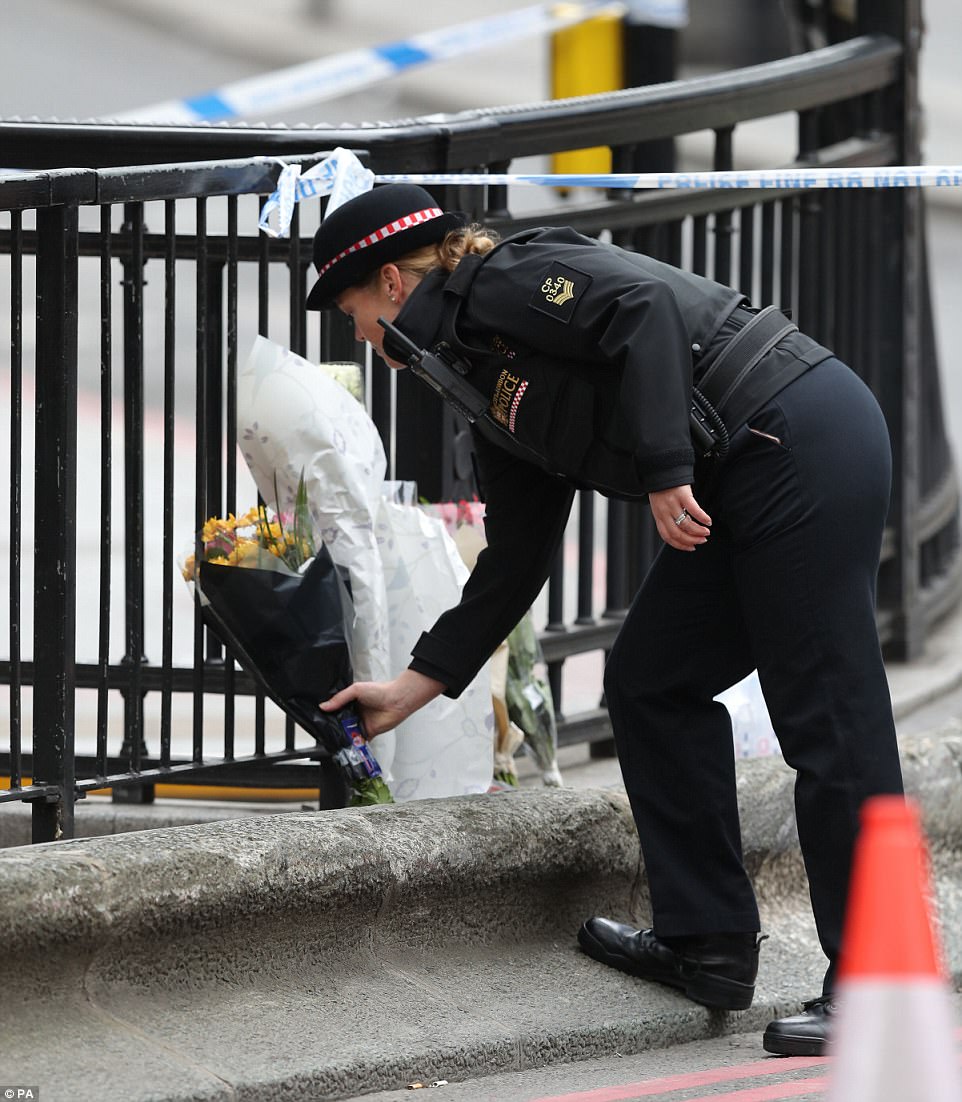 police-help-people-lay-flowers-for-london-terror-attack-victims