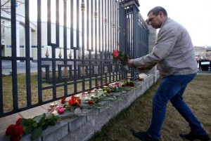 A Man Lays Flowers For Russian Metro Blast Victims